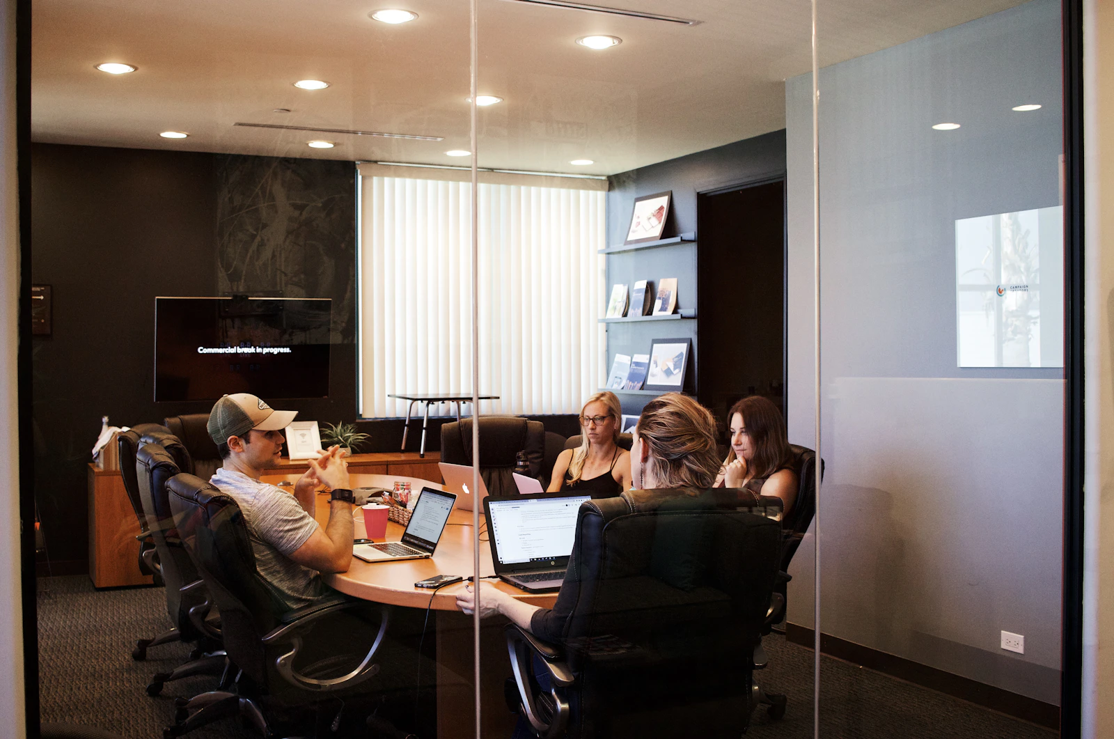 Professionals sharing ideas around a table in a bright workspace